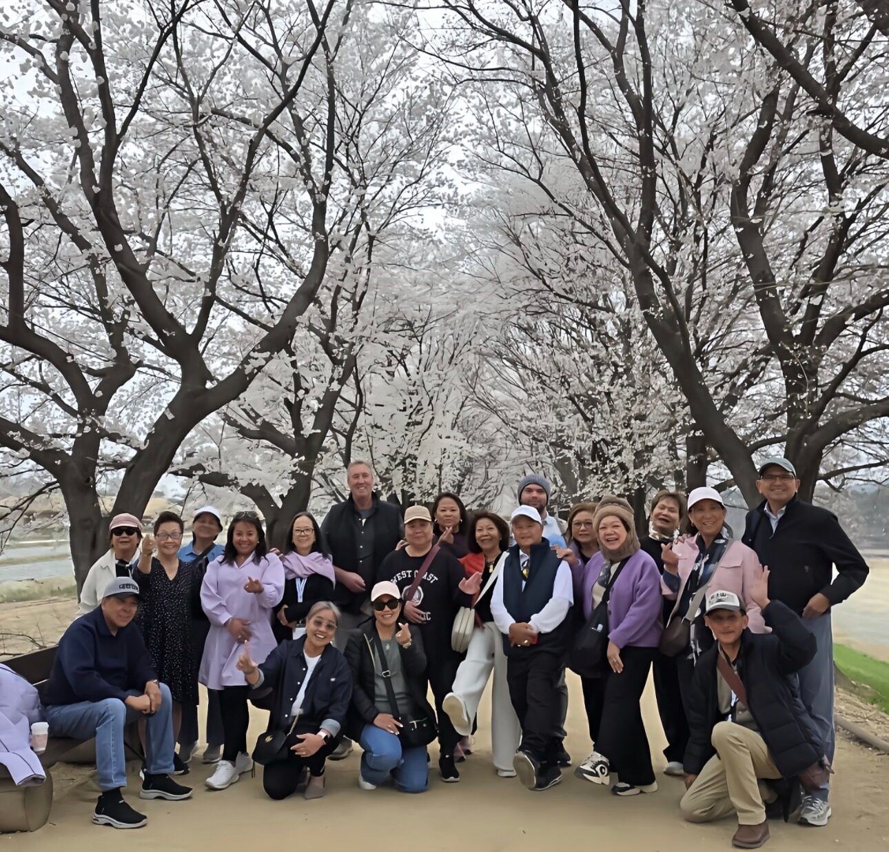 Inspiring Vacations group under cherry blossoms