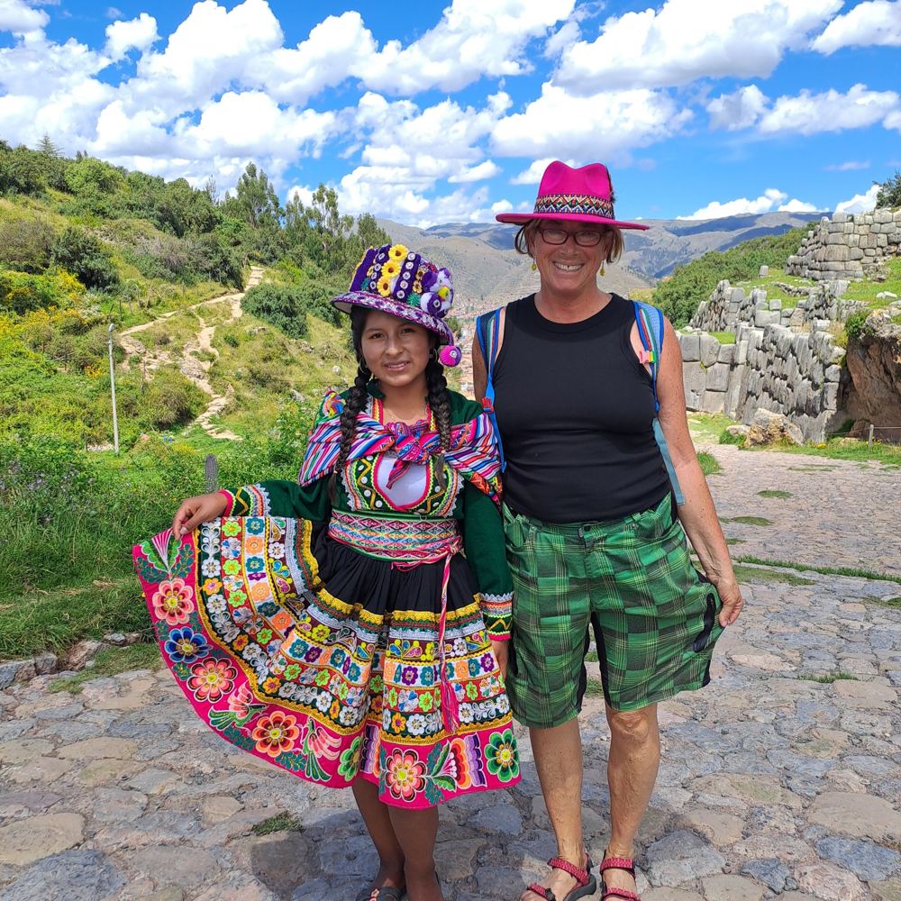 A traveller in a pink hat at Sacsayhuaman above Cusco