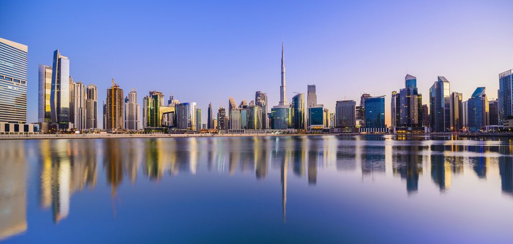 The Dubai skyline and Burj Khalifa reflected at dusk, UAE
