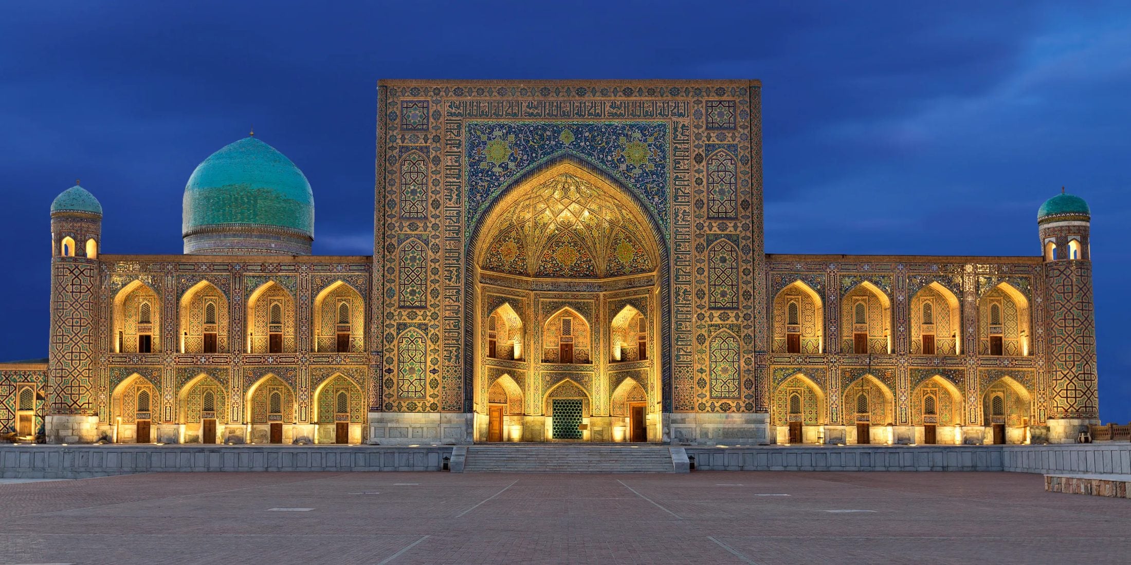 Registan Square illuminated at dusk, Samarkand, Uzbekistan
