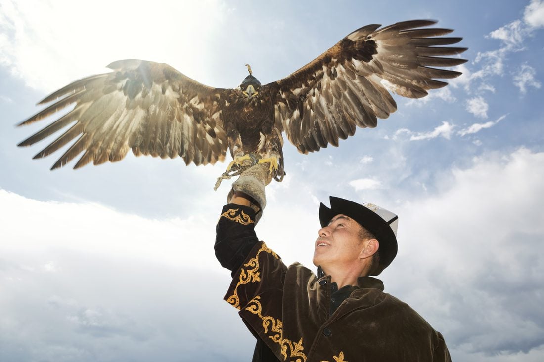 A Kyrgyz eagle hunter with a golden eagle
